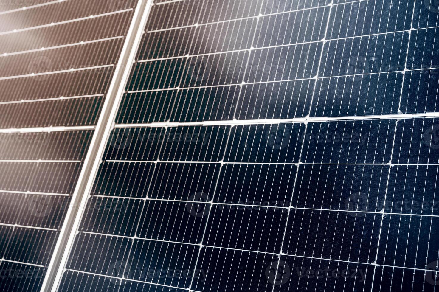 texture of cell of modern black solar panel at sunset in close-up. Renewable green energy photo