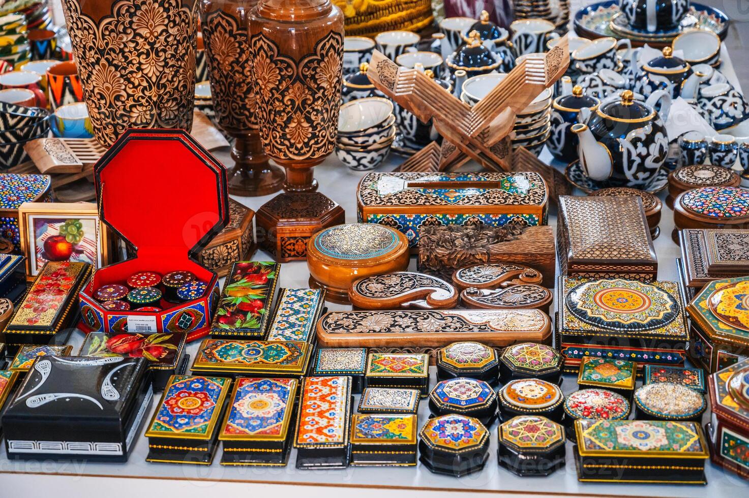 traditional handmade wooden carved Uzbek caskets hand-painted in oriental souvenir shop in Uzbekistan photo