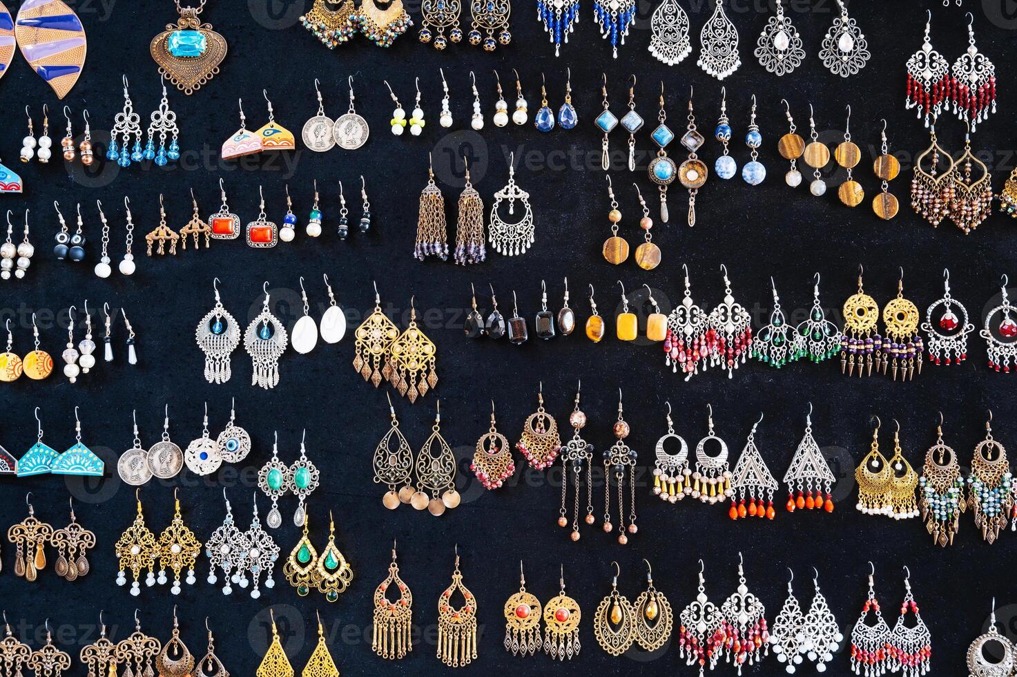 traditional oriental Uzbek earrings in Indian Asian ethnic style on a black background photo