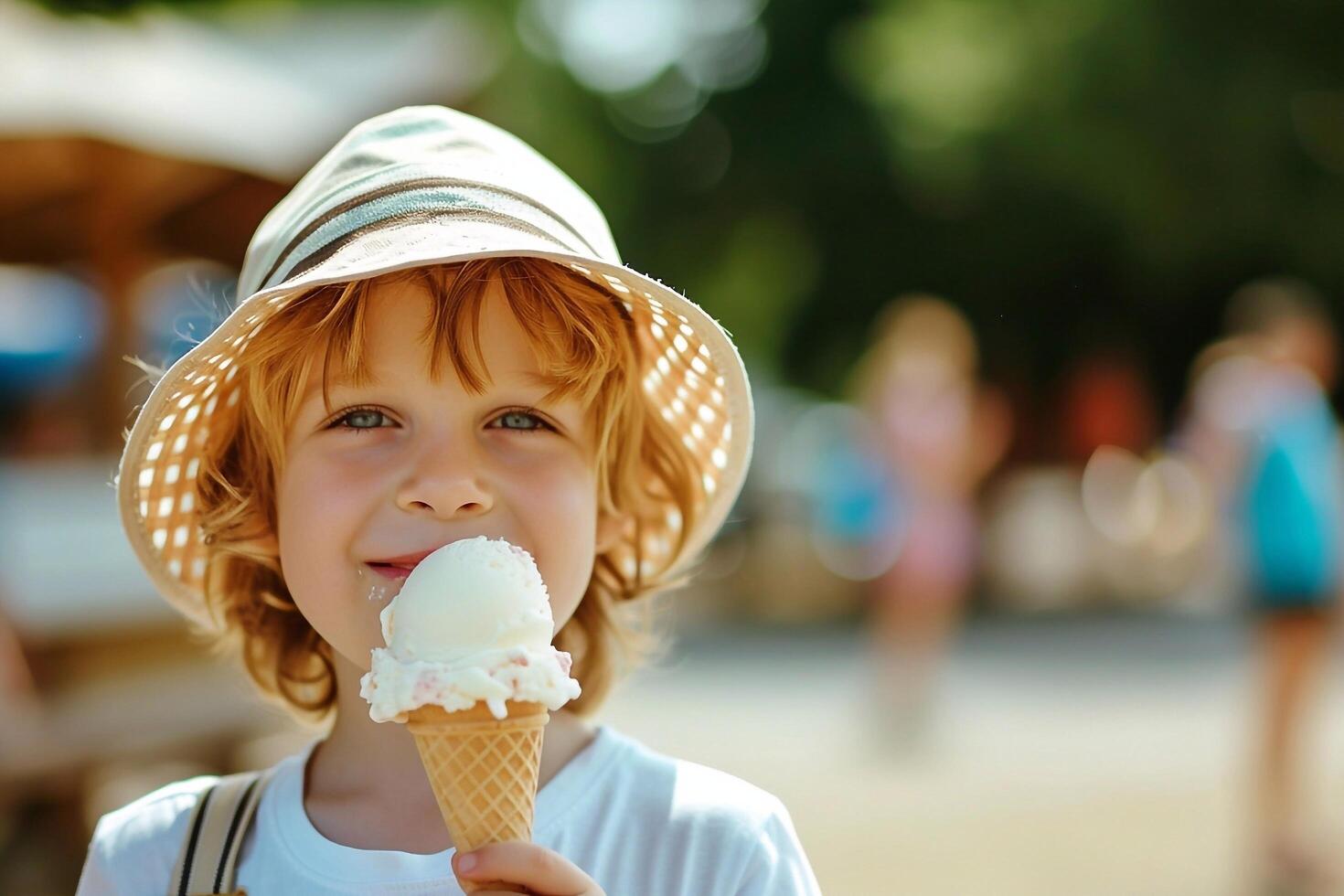 Cute little boy eating ice cream outdoors on summer day. photo