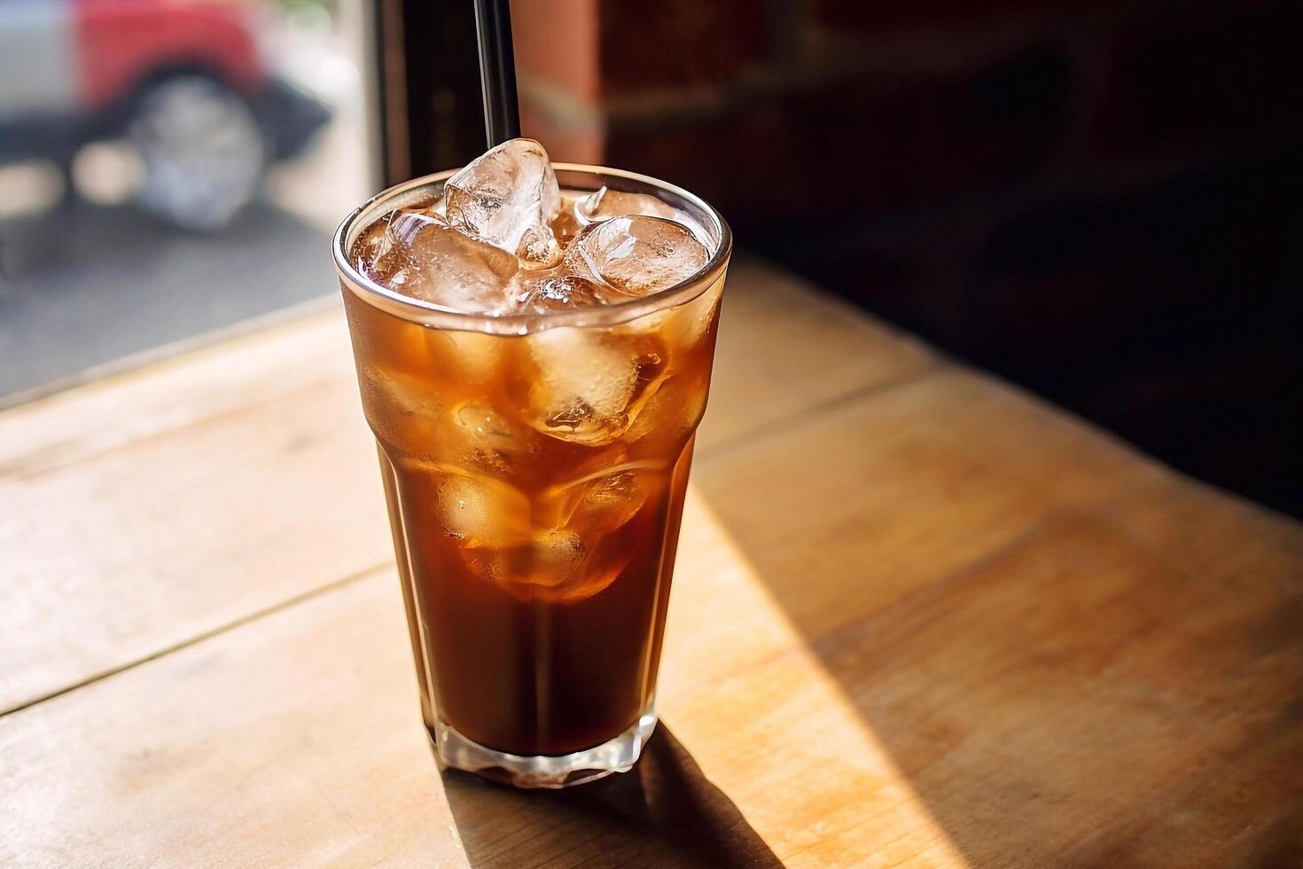 Coffe with ice cubes on wooden table in coffee shop photo