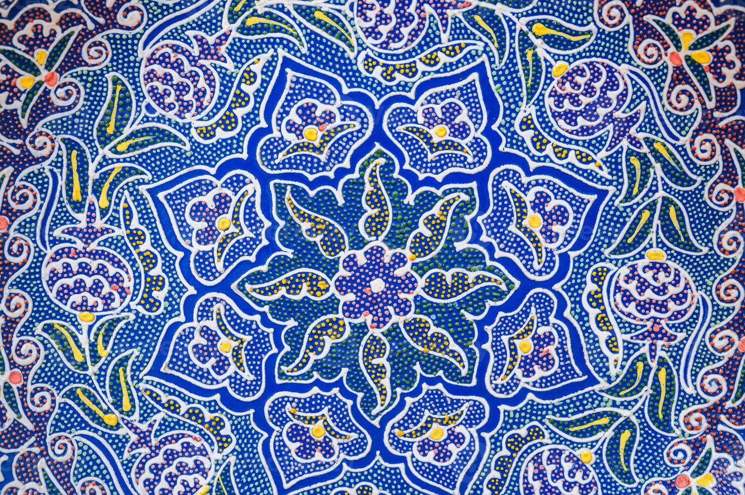 pattern on traditional oriental Uzbek ceramic plates hand-painted closeup in Arabesque style photo