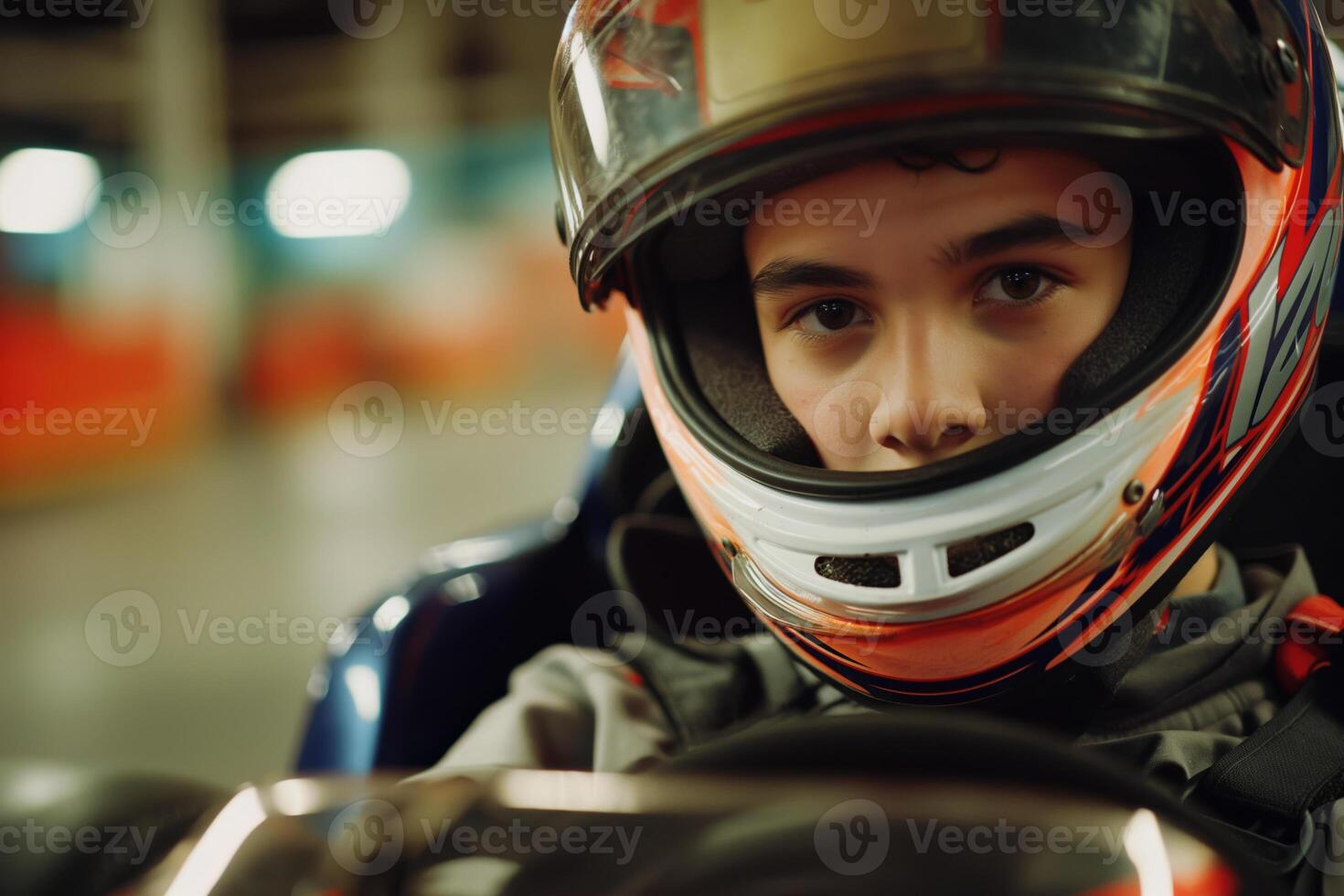 Young Racer in Helmet Focused on GoKart Racing Action in Indoor Track photo