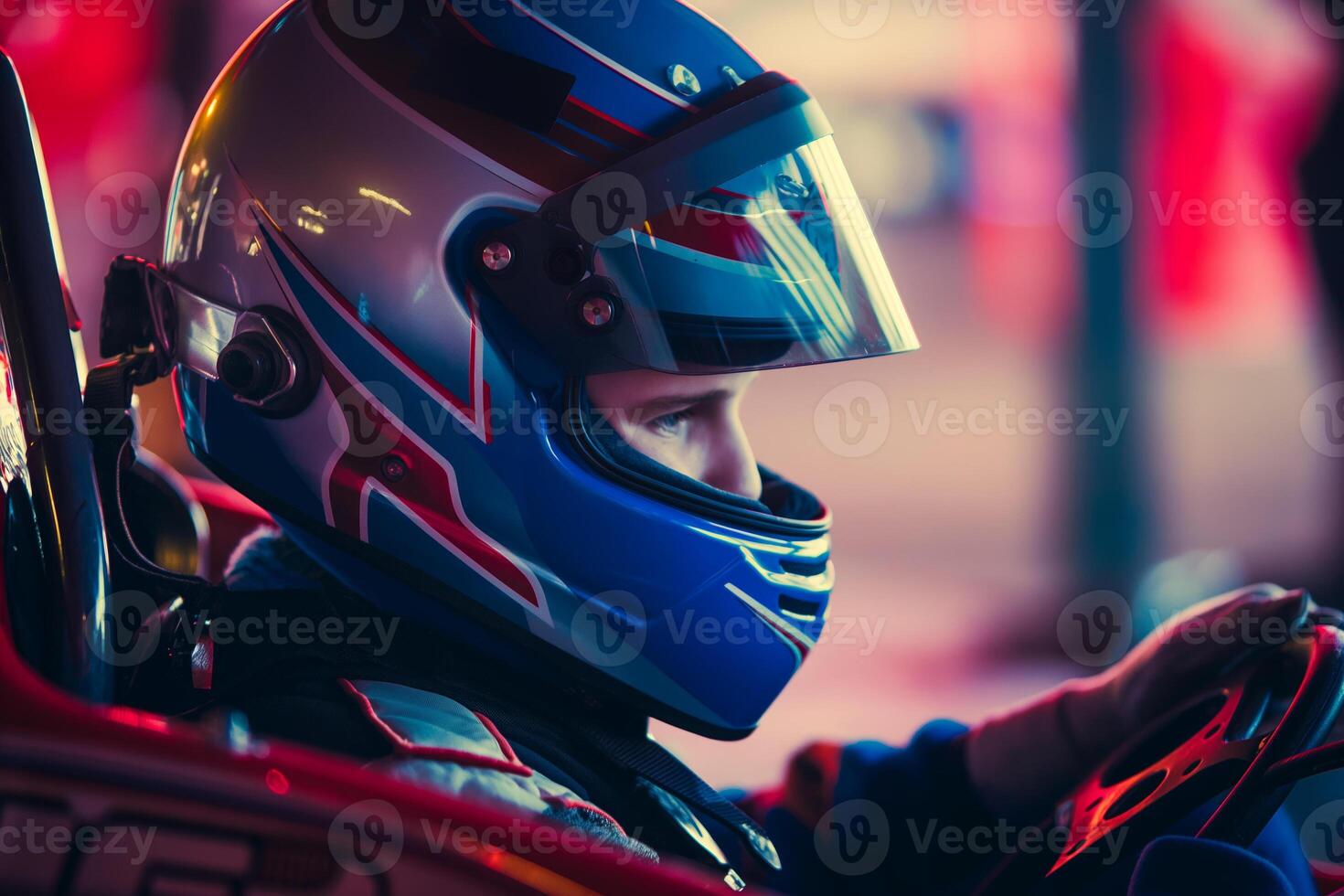 CloseUp of Racer in Colorful Helmet Driving GoKart During Nighttime Race photo