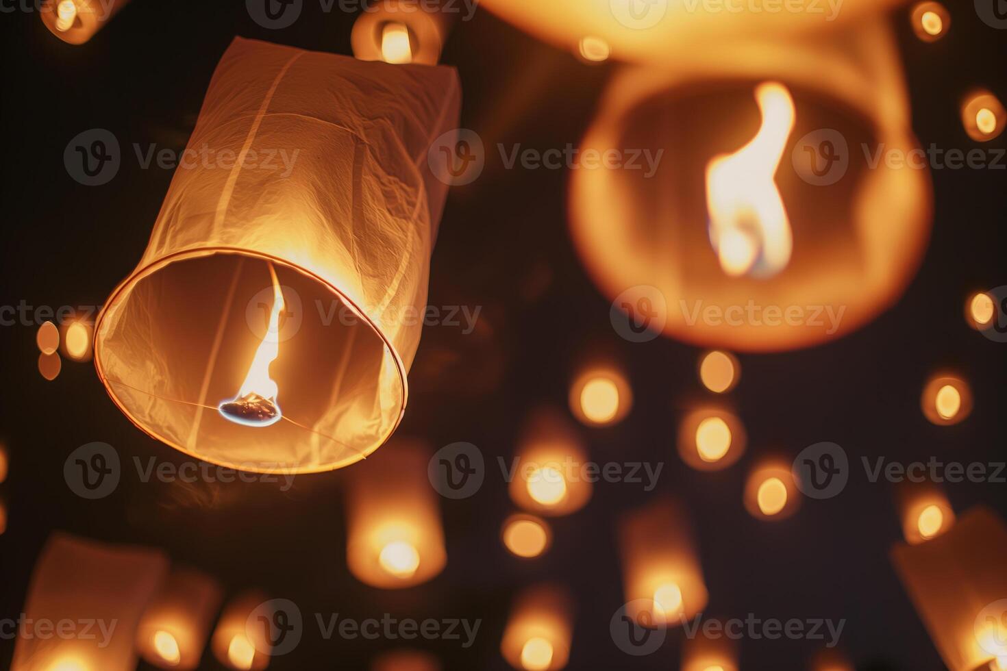 Floating Lanterns Night Festival with Glowing Warm Lights Against Dark Sky photo