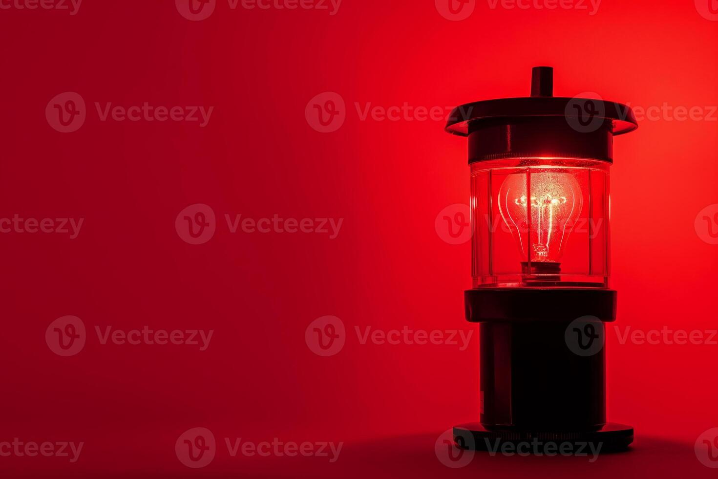 Vintage Lantern with Red LED Light on a Red Background photo