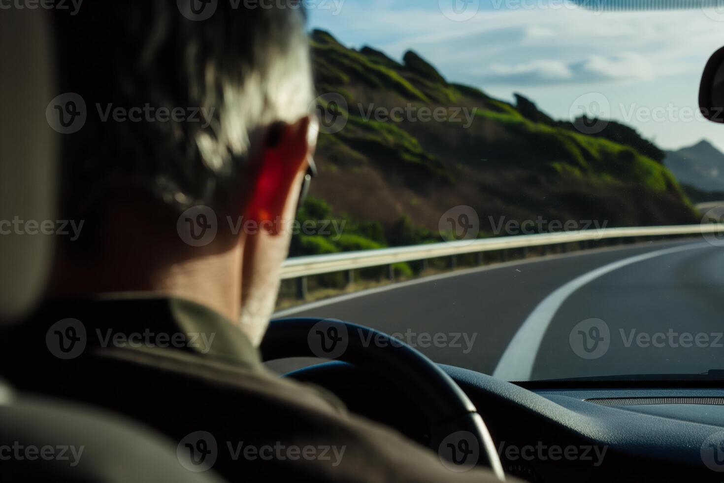Scenic Road Trip Man Driving on a Curvy Highway with Lush Green Hills in the Background photo
