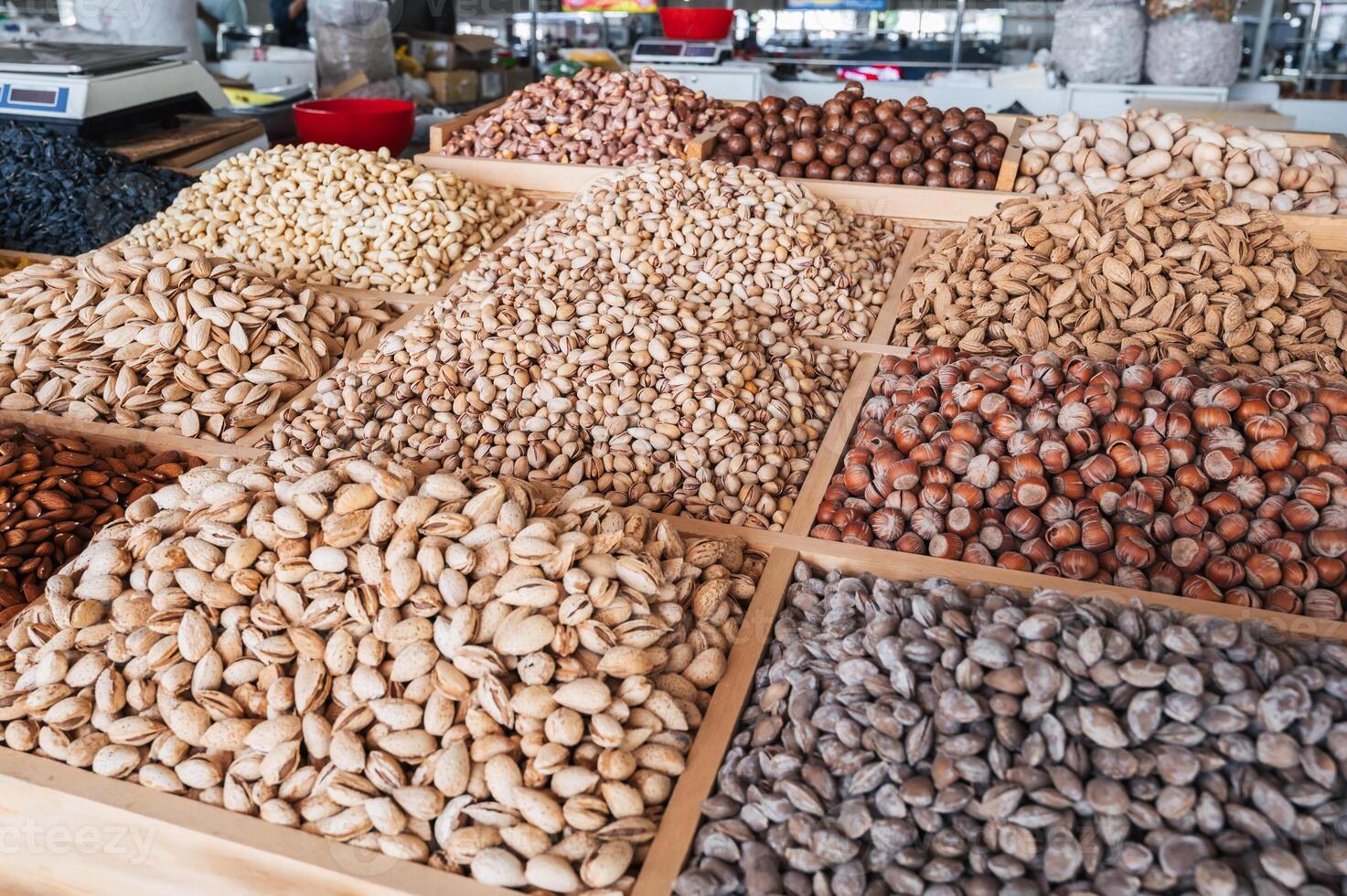 assortment of different nuts on the counter at oriental bazaar. Almonds, pistachios, hazelnuts, macadamia, pecans and cashews photo