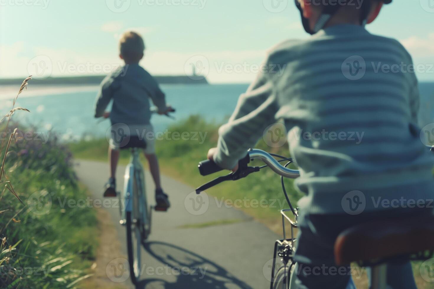 Children Riding Bikes on Coastal Path with Scenic Ocean View photo