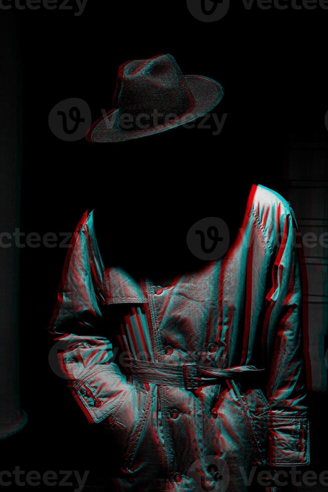 dark mystical silhouette of a man in a hat at night photo