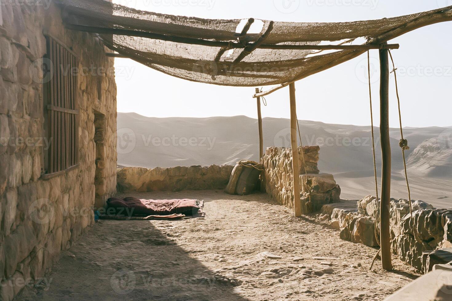 Rustic Desert Shelter with Shade Canopy and Mountain Views in Remote Landscape photo