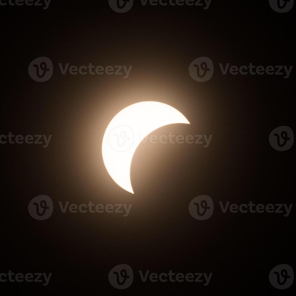 Early stage of the solar eclipse in April 2024 with the moon starting to cover the sun photo
