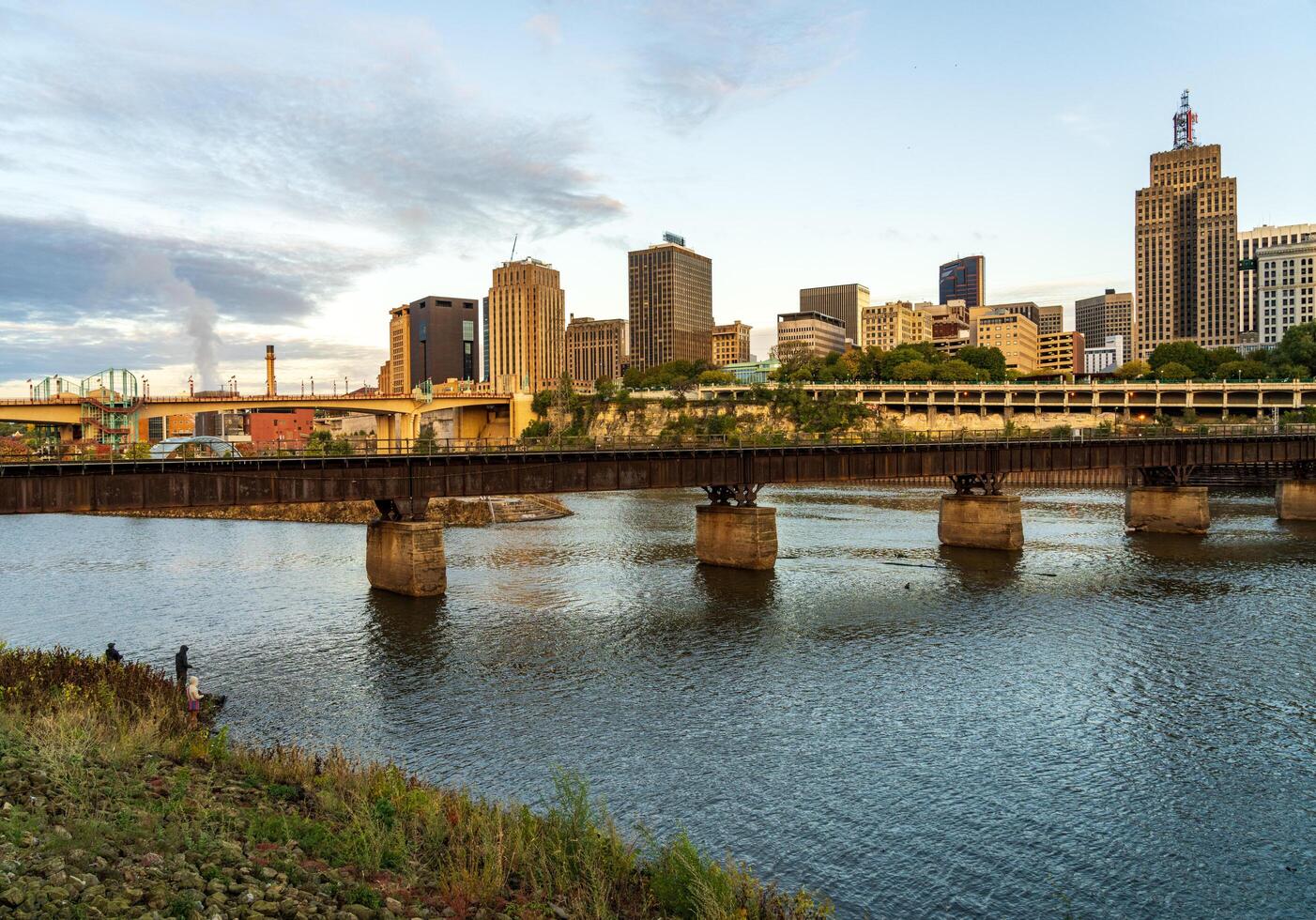 St Paul, MN - 14 October 2023. Early morning cityscape of Twin Cities in Minnesota and Mississippi river with railroad bridge photo