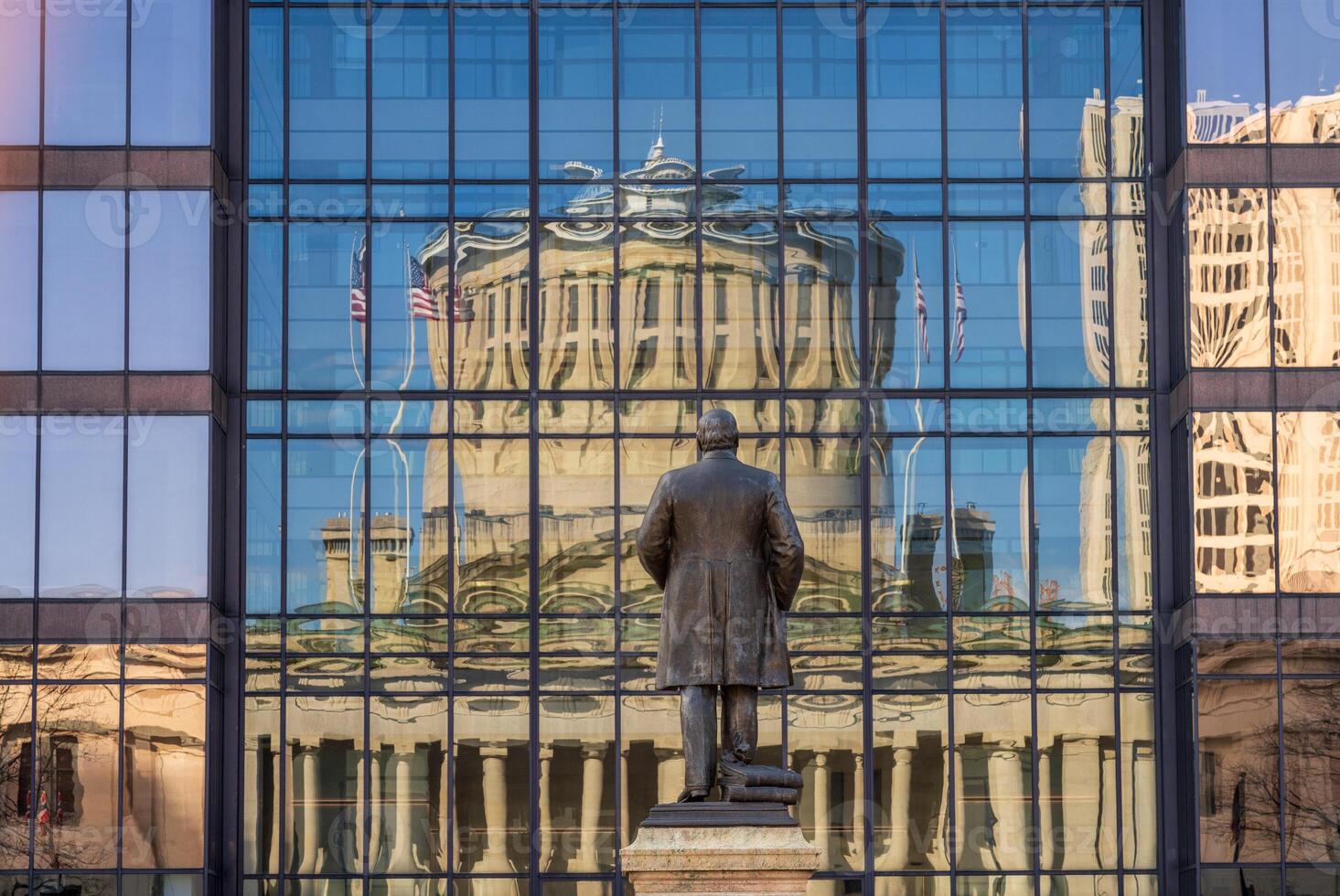 McKinley memorial in front of a reflection of the Ohio state Capitol building in the windows of an office building across the street in Columbus, OH photo