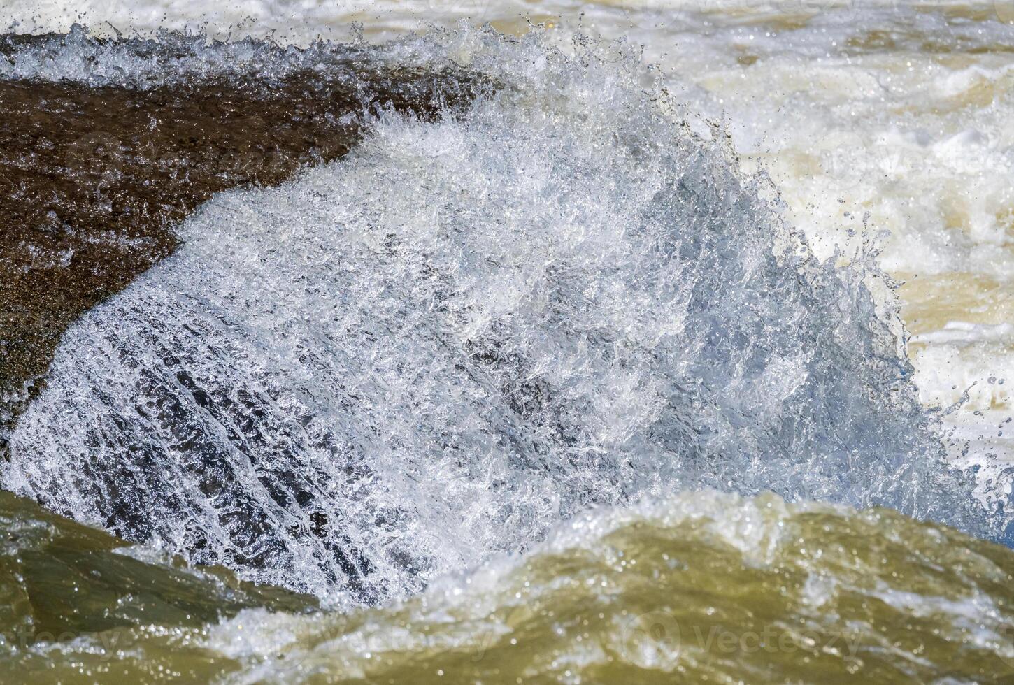 Frozen motion view of raging water flowing over rocks of Valley Falls State Park on Tygart River near Fairmont West Virginia photo