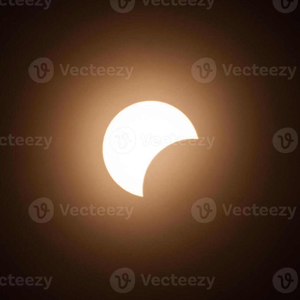 Early stage of the solar eclipse in April 2024 with the moon starting to cover the sun photo