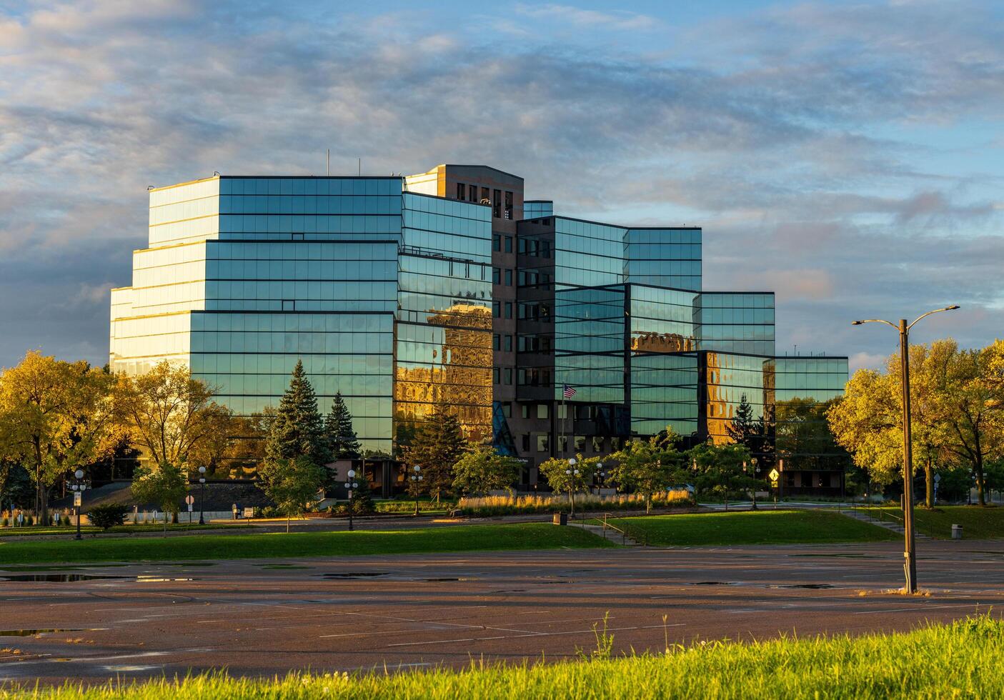 St Paul, MN - 14 October 2023. Sunrise behind Comcast offices on River Park Plaza in Minnesota photo