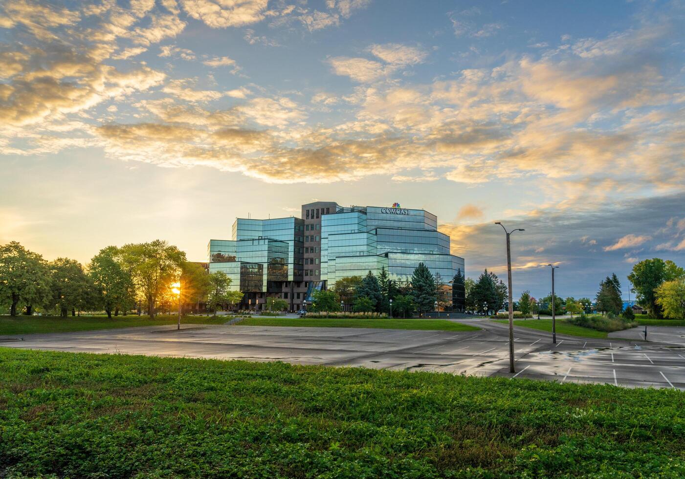 St Paul, MN - 14 October 2023. Sunrise behind Comcast offices on River Park Plaza in Minnesota photo