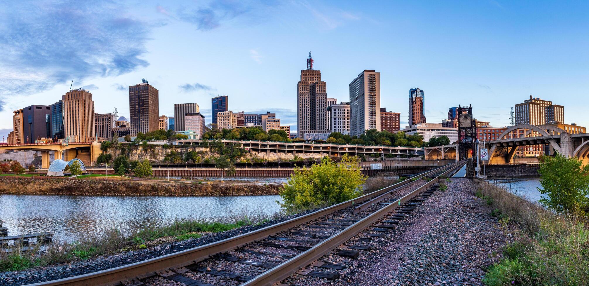 St Paul, MN - 14 October 2023. Early morning cityscape of Twin Cities in Minnesota and Mississippi river with railroad bridge photo