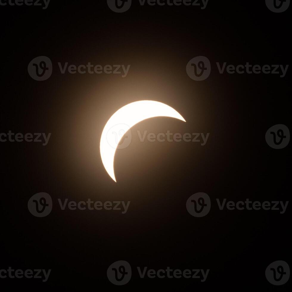 Early stage of the solar eclipse in April 2024 with the moon starting to cover the sun photo