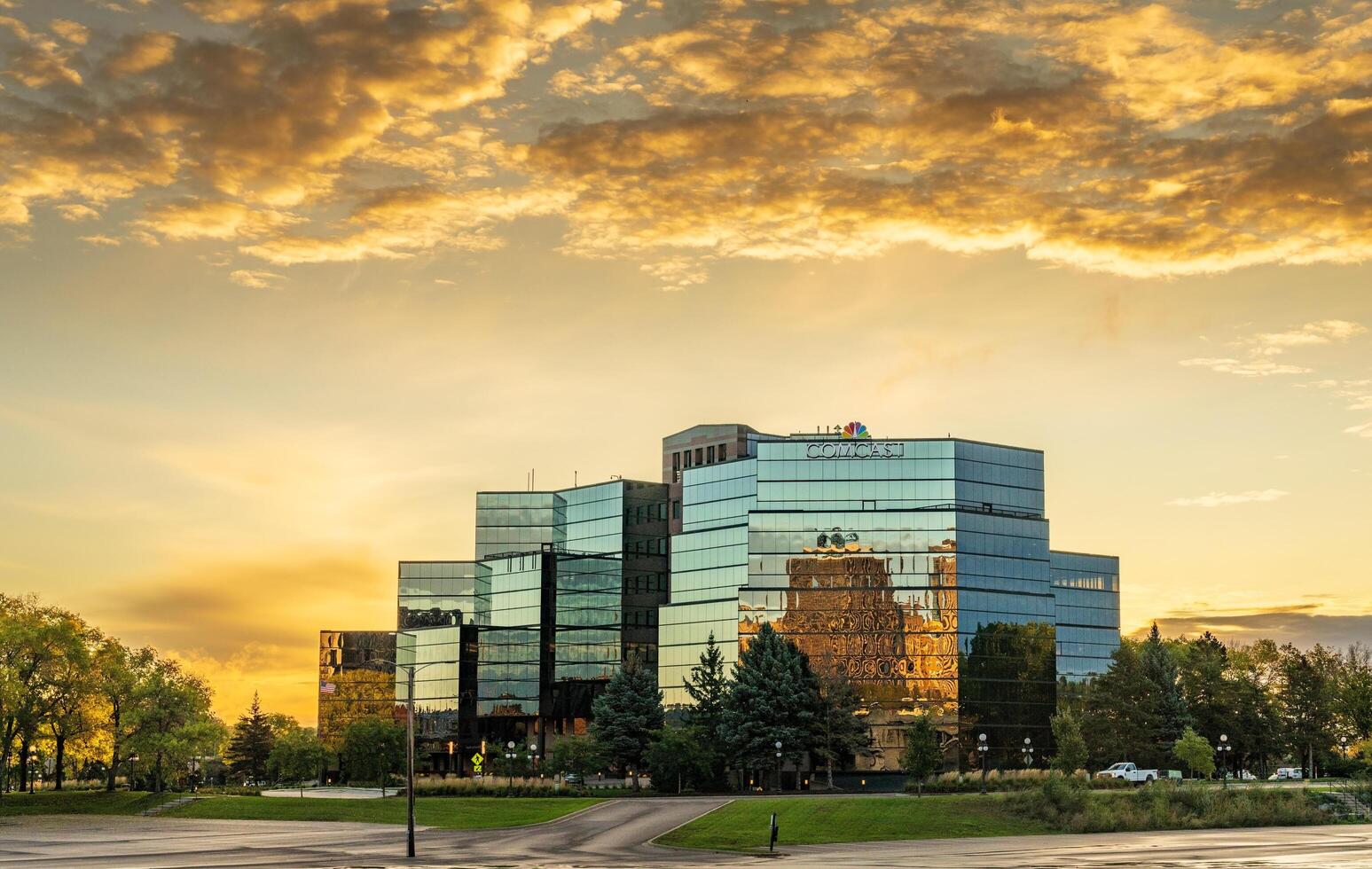 St Paul, MN - 14 October 2023. Sunrise behind Comcast offices on River Park Plaza in Minnesota photo
