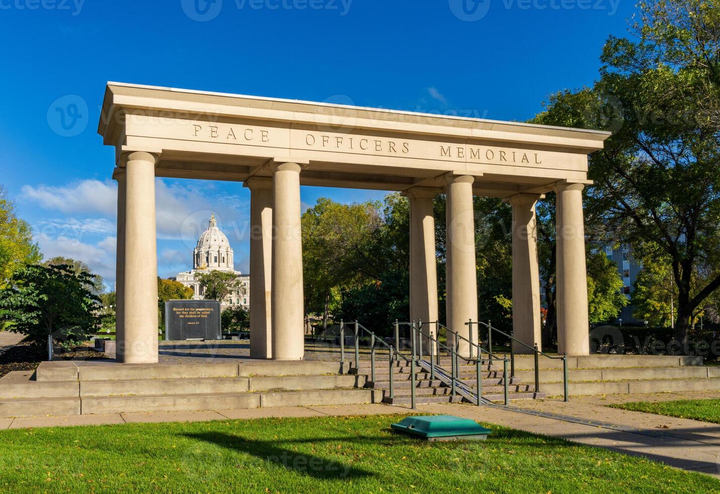 Dome of the Capitol building in the state of Minnesota in Saint Paul, MN behind Peace Officers Memorial structure photo