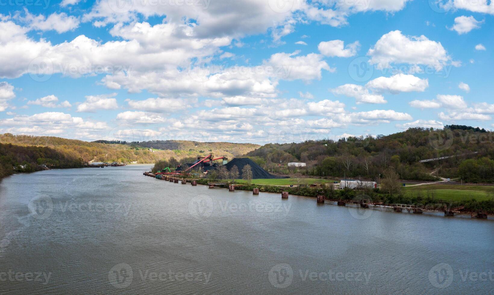 Coal stored by Monongahela river in Vestaburg Pennsylvania ready for transport by barge to local power stations photo