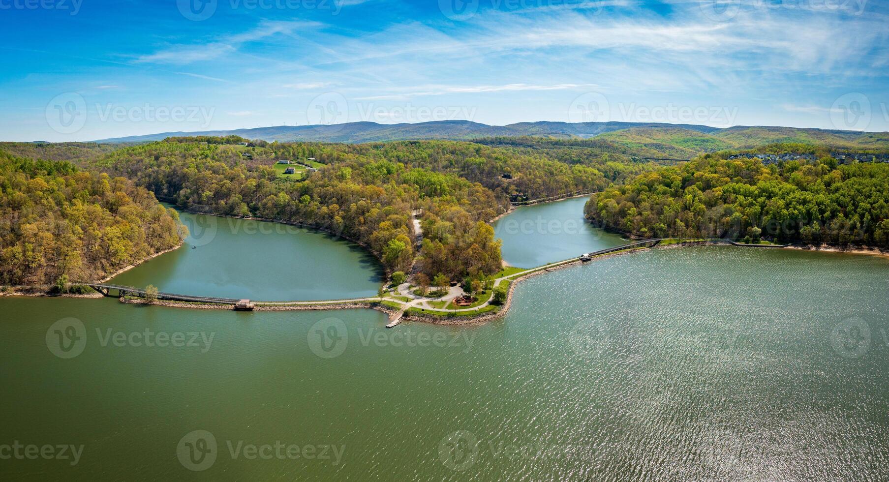 Aerial view as sun casts warm light on the park at Cheat Lake near Morgantown West Virginia on a beautiful calm spring morning photo