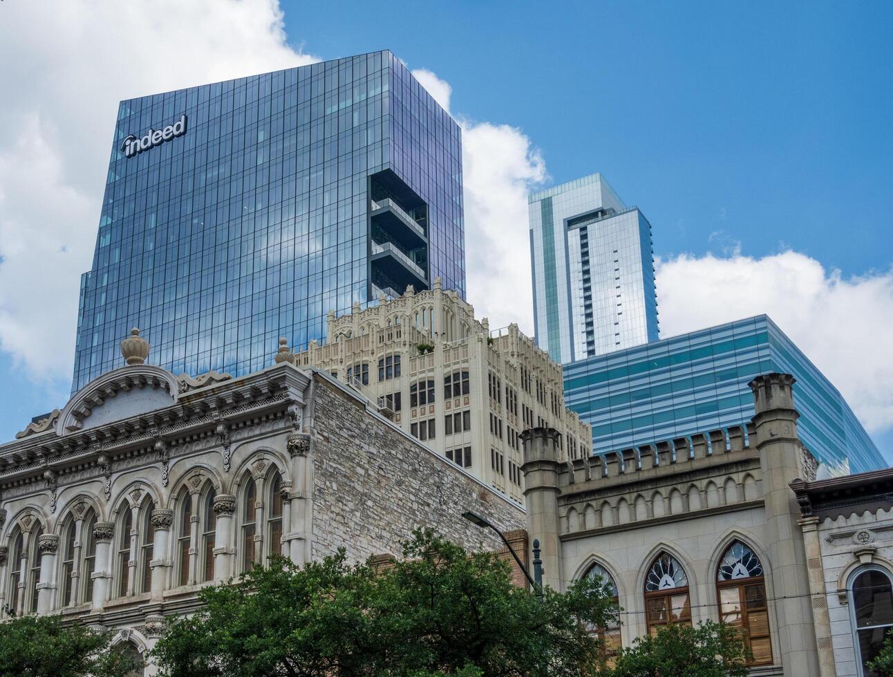 Austin, Texas - 15 June 2024. Indeed HQ skyscraper soars above older historic stone buildings on Congress Avenue in Austin, TX photo