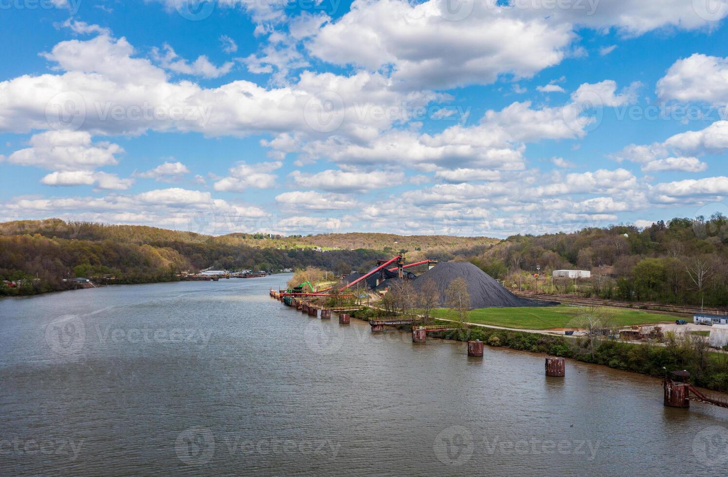 Coal stored by Monongahela river in Vestaburg Pennsylvania ready for transport by barge to local power stations photo