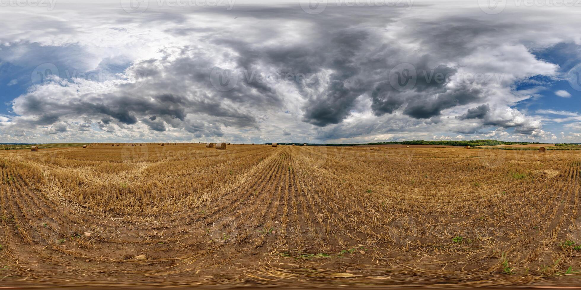 spherical 360 hdri panorama on rye and wheat fields with hay bales with rain storm clouds in dark sky in equirectangular seamless projection, as skydome replacement in drone panoramas photo
