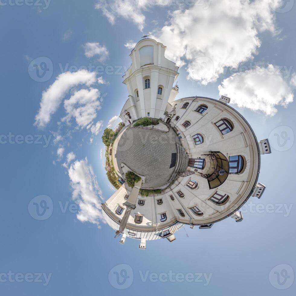 little planet transformation of spherical panorama 360 degrees overlooking church in center of globe in blue sky. Spherical abstract aerial view with curvature of space. photo