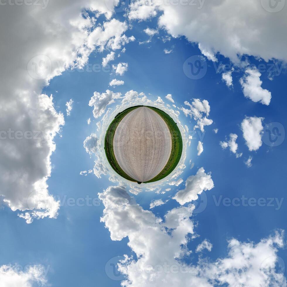 simple little tiny planet without buildings in blue sky with beautiful clouds. Transformation of spherical panorama 360 degrees. Spherical abstract aerial view. Curvature of space. photo