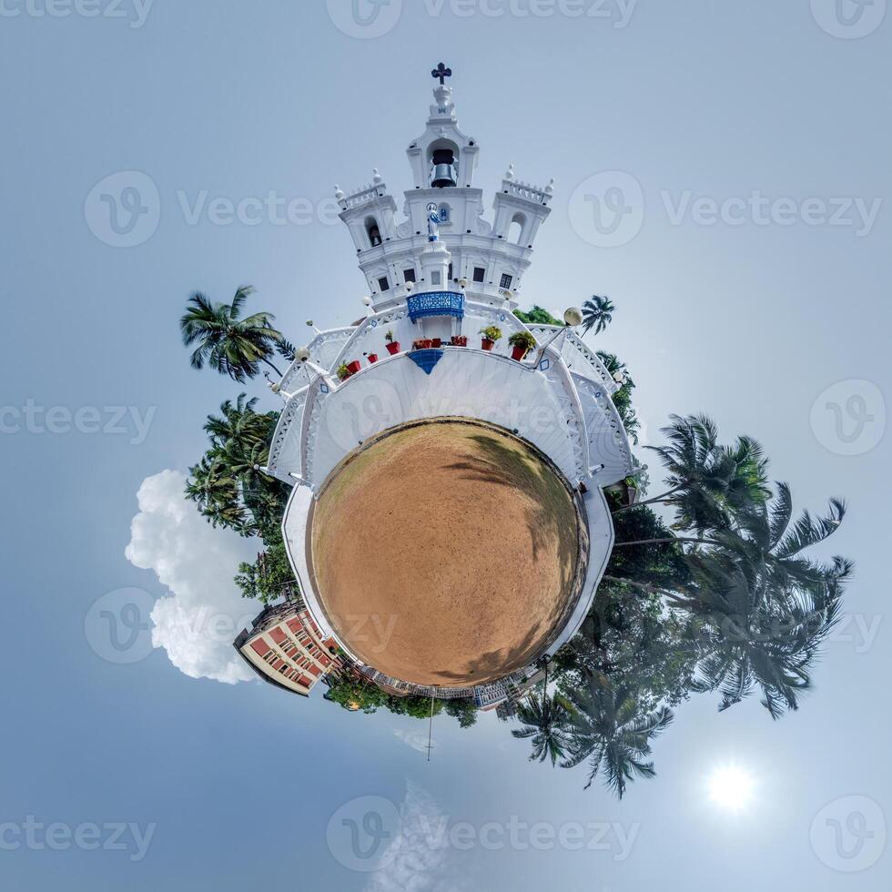 little planet transformation of spherical panorama 360 degrees overlooking church in center of globe in blue sky. Spherical abstract aerial view with curvature of space. photo