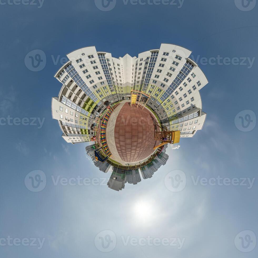 abstract swirling tiny planet spherical panorama of multi-storey buildings of skyscrapers of a residential complex in the form of a butterfly, bugs, crabs in blue sky photo