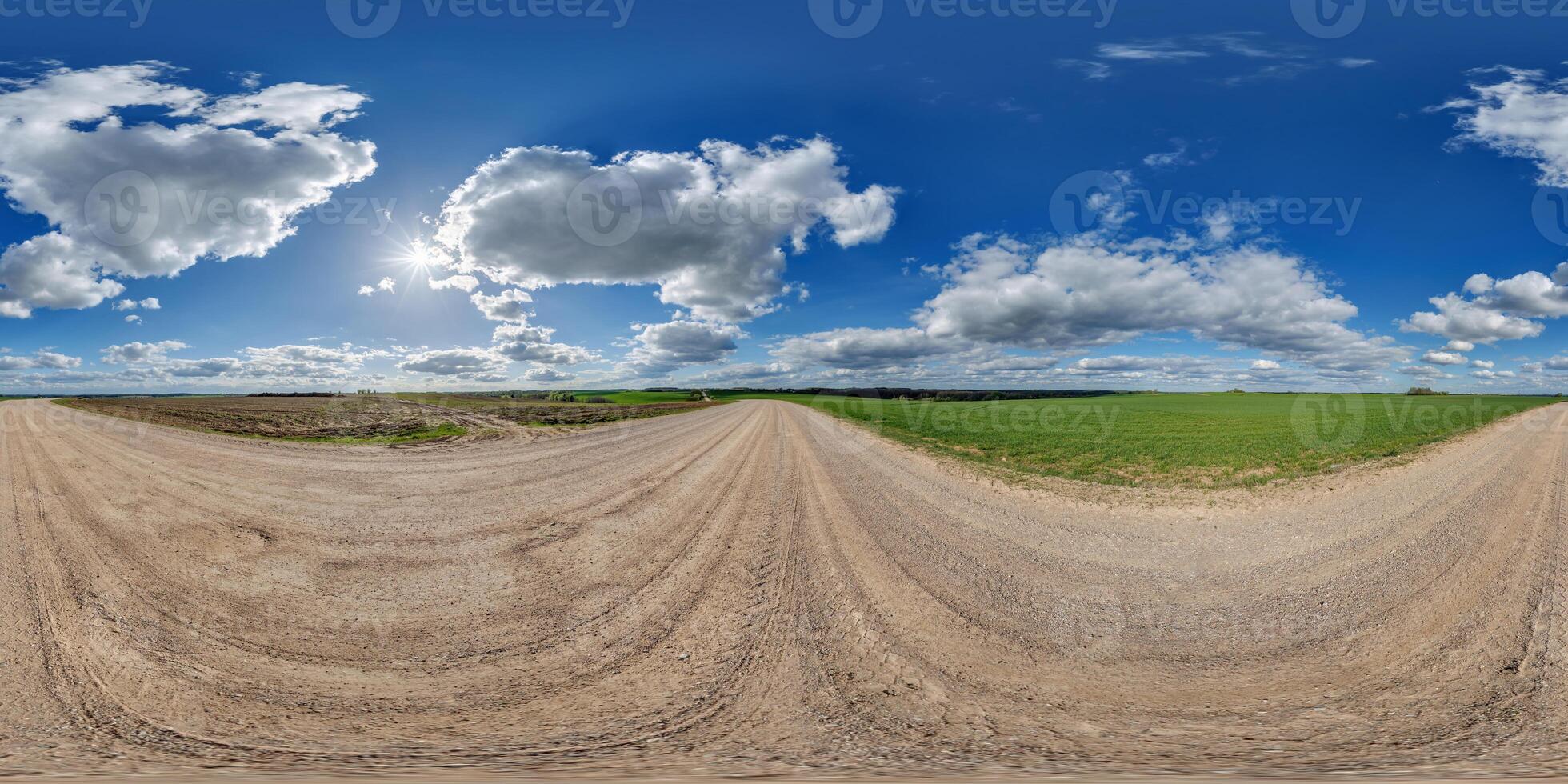 spherical 360 hdri panorama on gravel road with white clouds in blue sky in equirectangular seamless projection, as skydome replacement in drone panoramas, game development photo