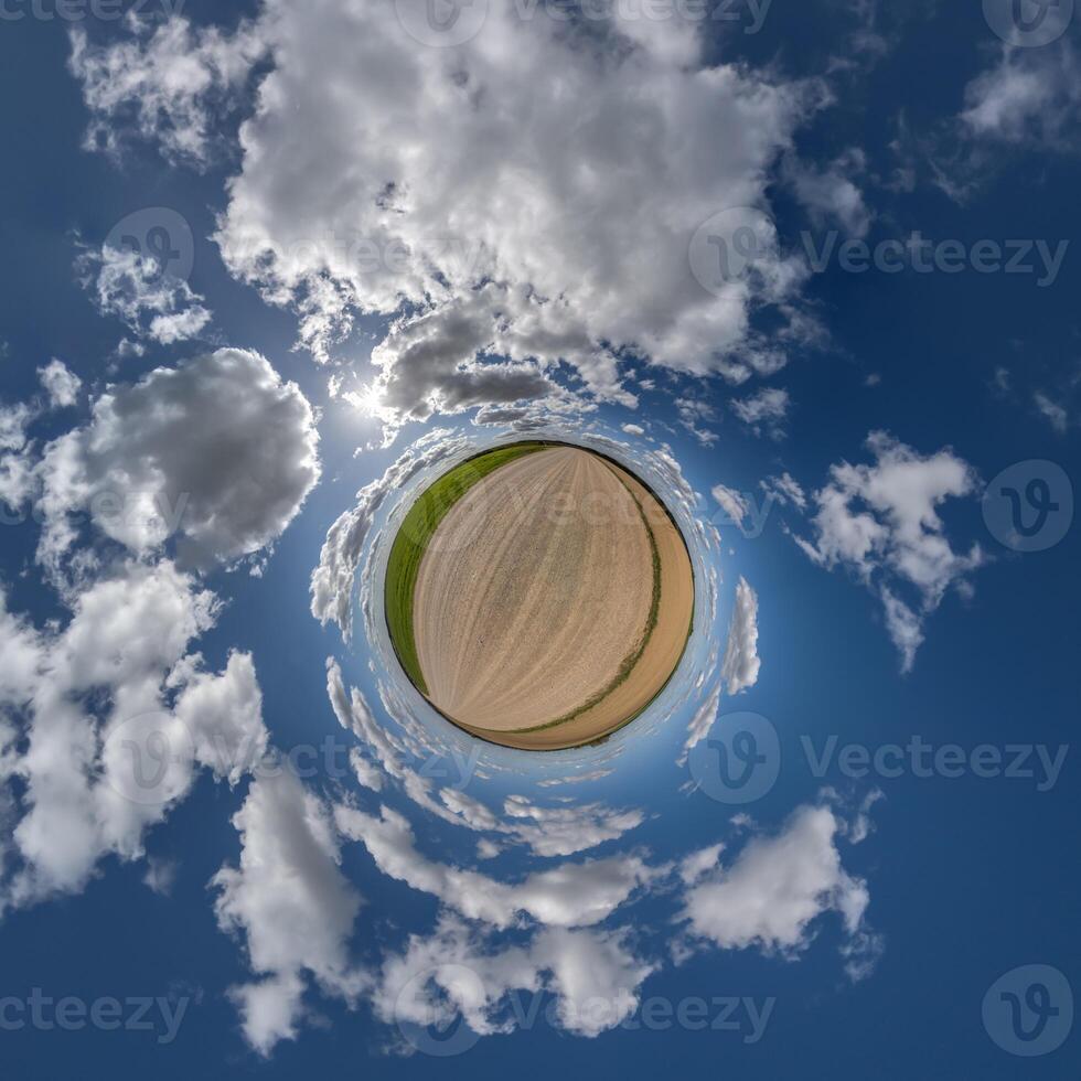 simple little tiny planet without buildings in blue sky with beautiful clouds. Transformation of spherical panorama 360 degrees. Spherical abstract aerial view. Curvature of space. photo
