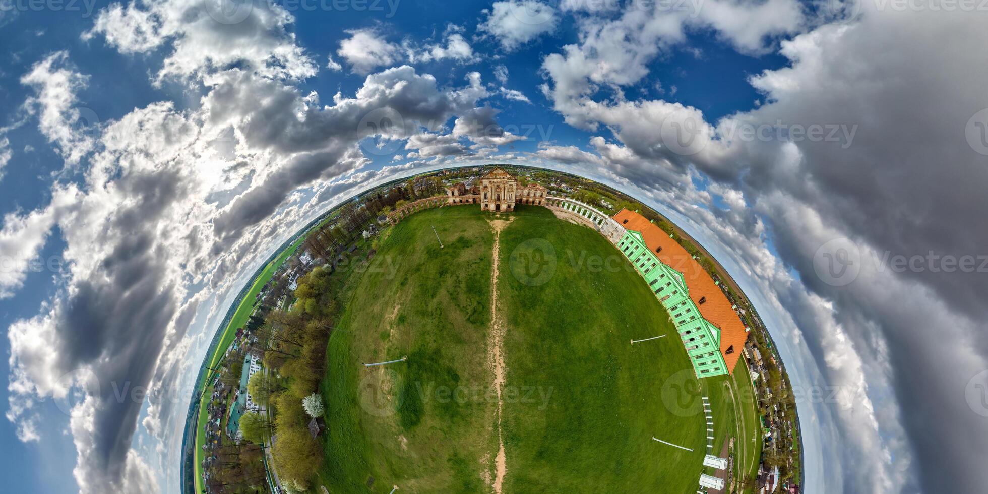 tiny planet and spherical aerial panorama view on street ancient medieval castle and historic buildings in blue sky with clouds photo