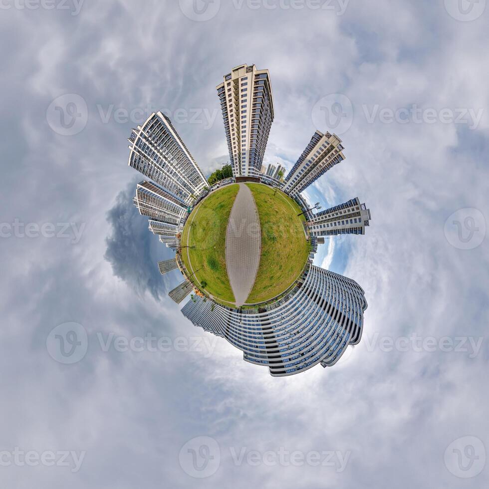 abstract swirling tiny planet spherical panorama of multi-storey buildings of skyscrapers of a residential complex in the form of a butterfly, bugs, crabs in blue sky photo