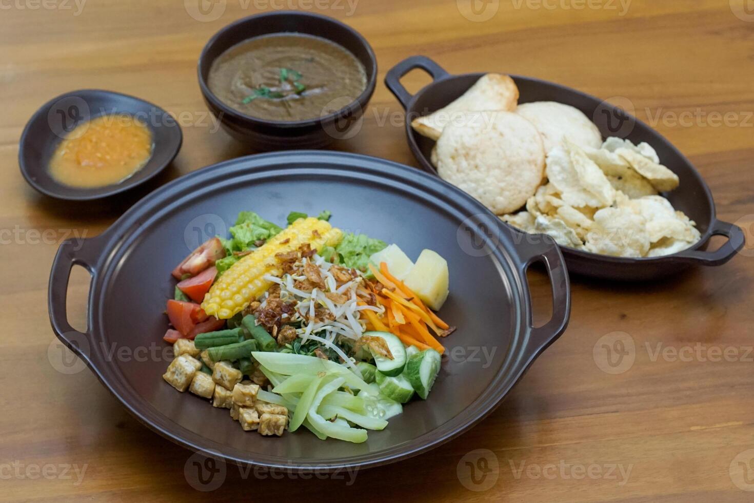 Close up of gado-gado ingredients in a plate, various vegetables and fried tempeh photo