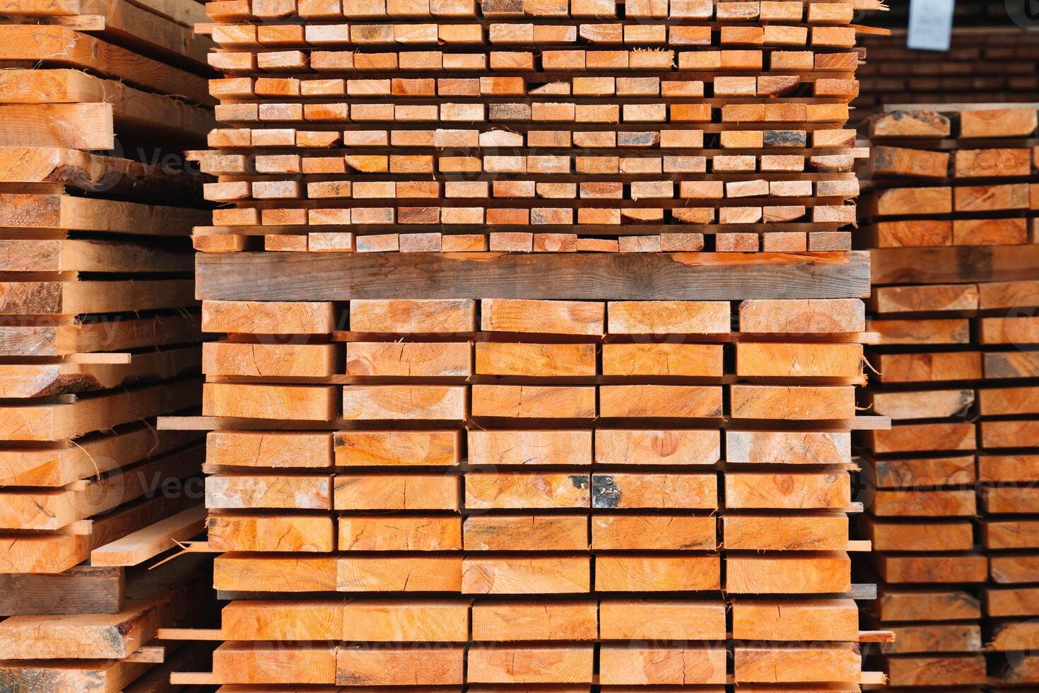 Lumber in a large warehouse. Wooden boards in the stack photo