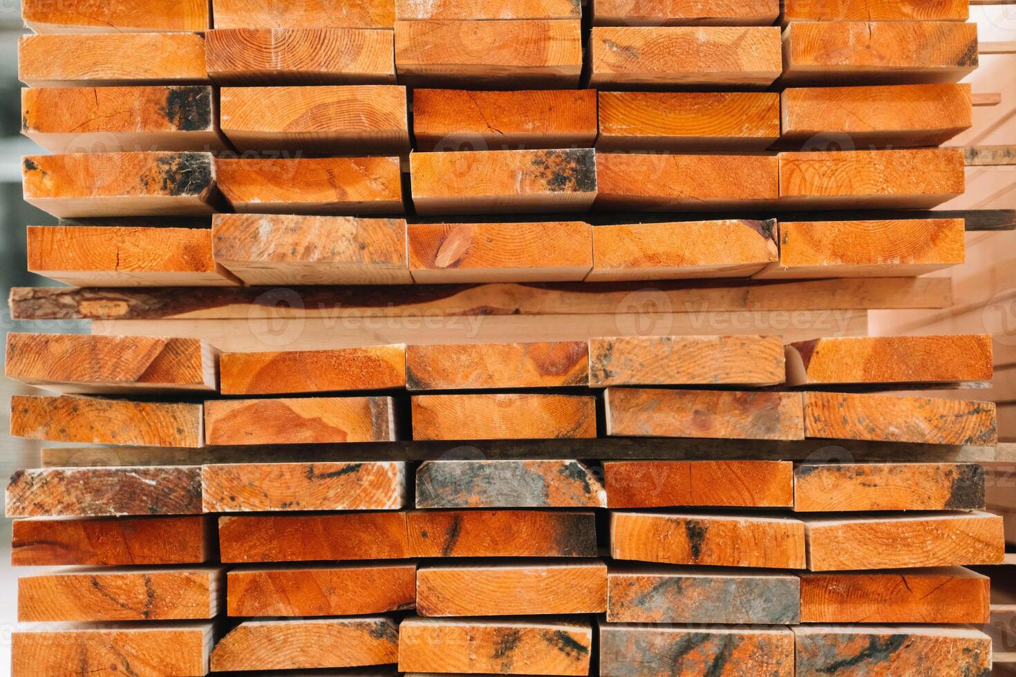 Stacks of lumber being stored in a warehouse photo