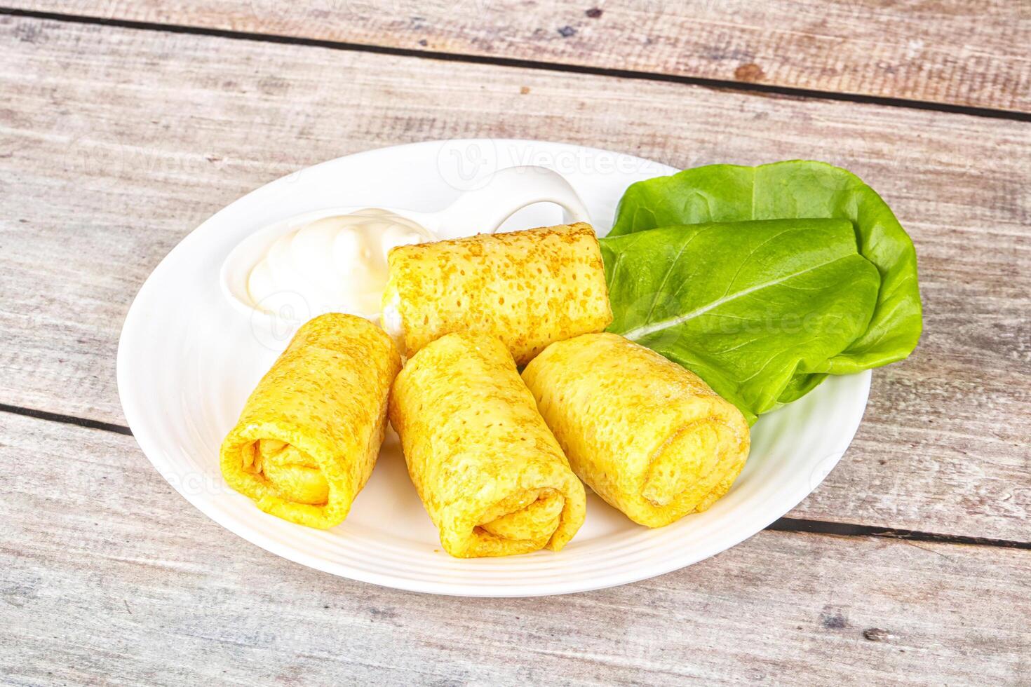 Stuffed pancakes with cream sauce photo