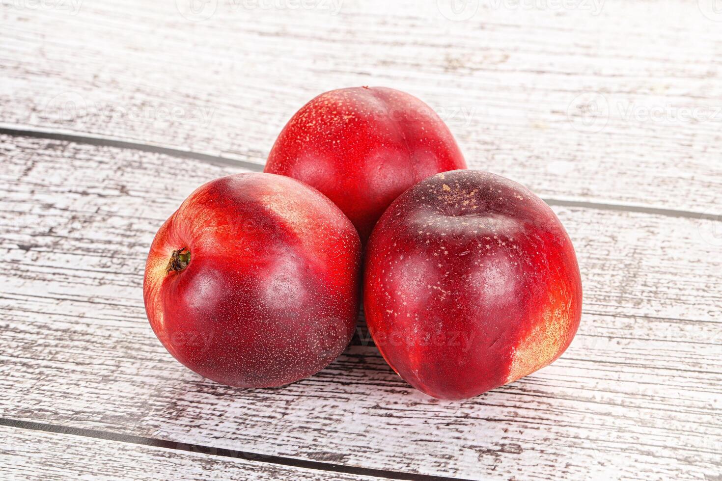 Ripe sweet juicy nectarines heap photo