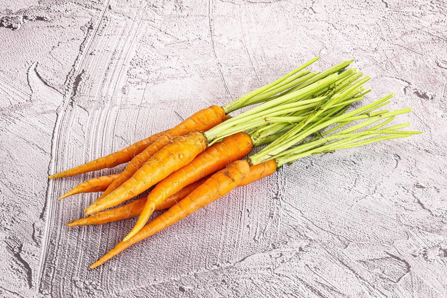 Young raw carrot heap isolated photo