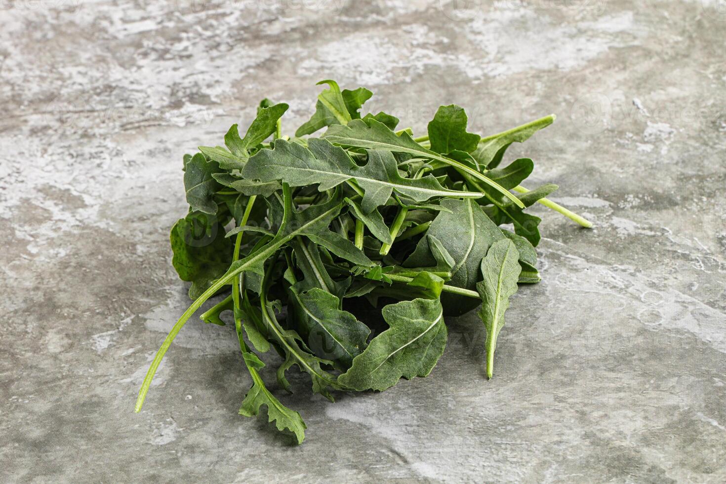 Green Arugula heap over background photo