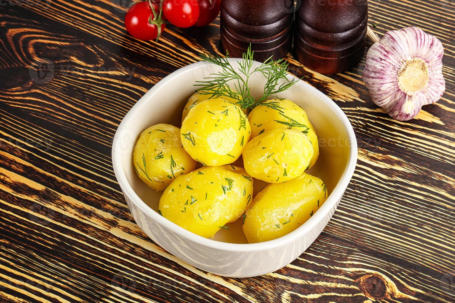 Boiled potato with oil and dill photo