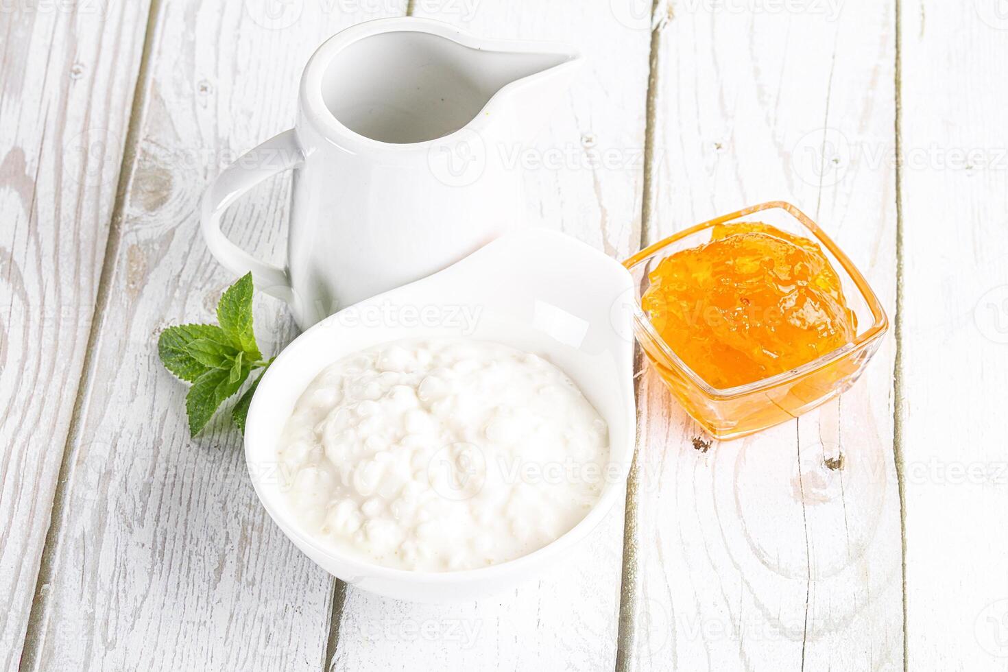 Grain curd with cream and jam photo