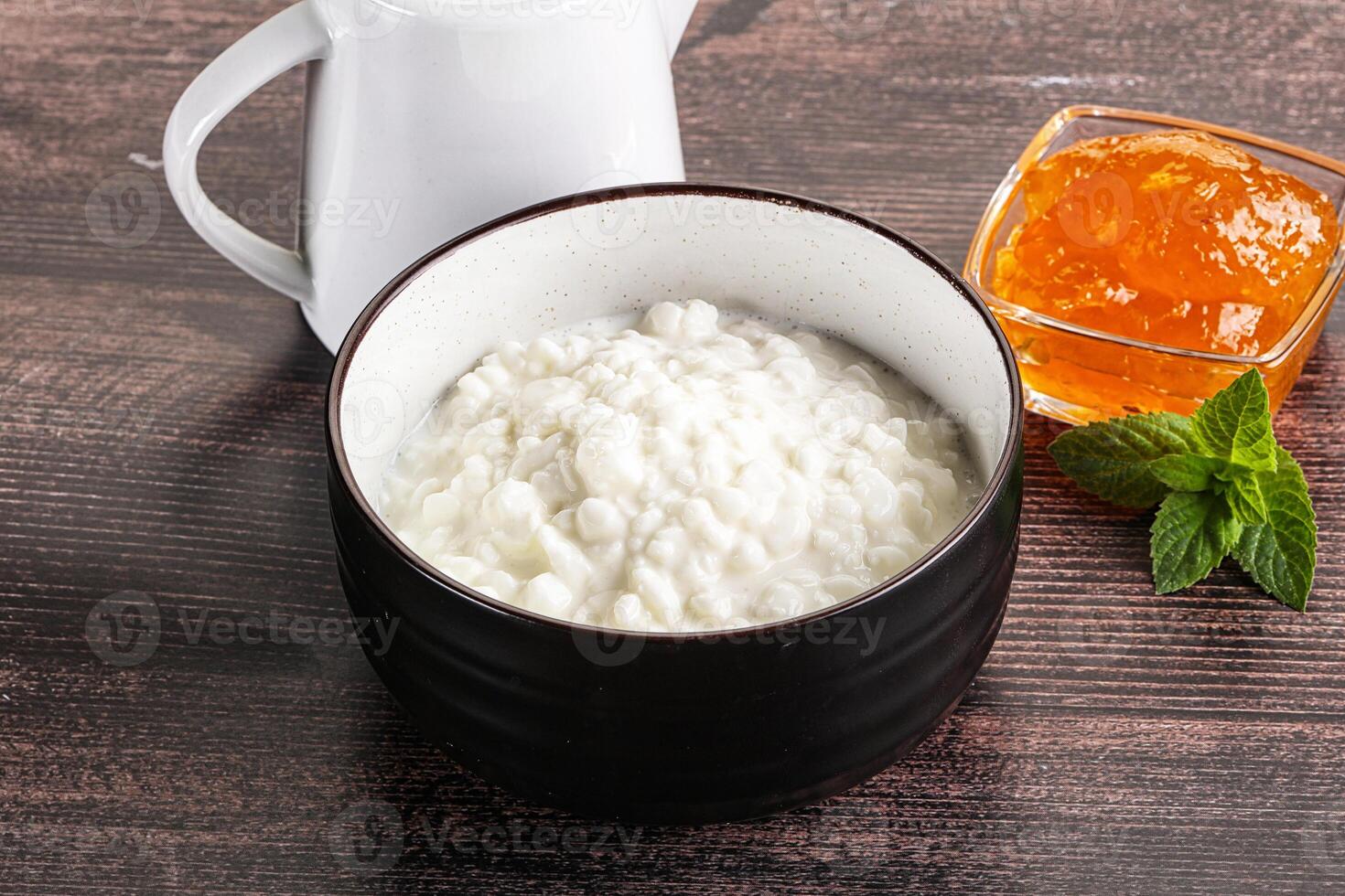 Grain curd with cream and jam photo