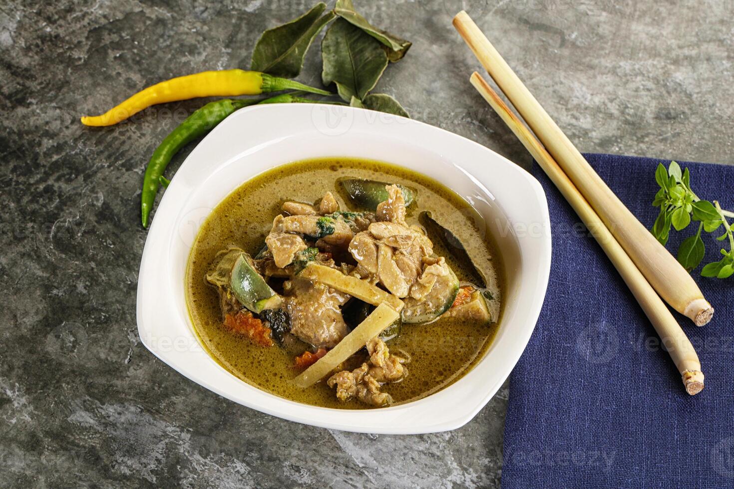 Thai green curry soup with basil photo